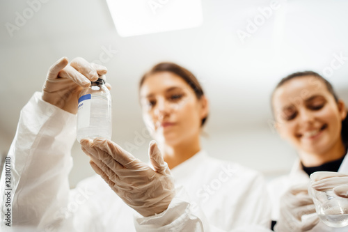 Female pharmacist developing parenteral antibody antivirus.New vaccine patent.DNA blood sample analysis.Antibiotic safety control test examination.Biochemical laboratory chemist.Drug manufacure