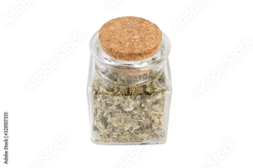 dried artichoke leaves or in latin Cynarae folium in a glass jar isolated on white background. medicinal healing herbs. herbal medicine. alternative medicine