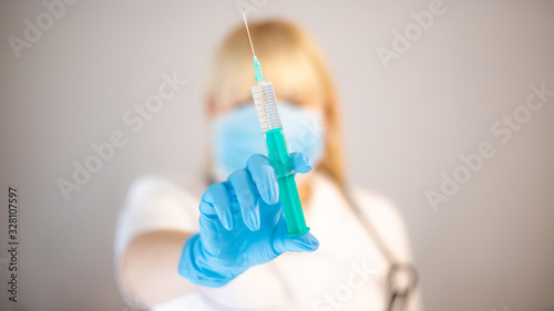 Nurse with syringe in hand.