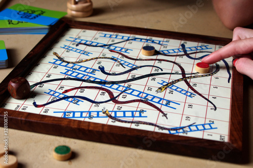 kid playing vintage snakes and ladders board game