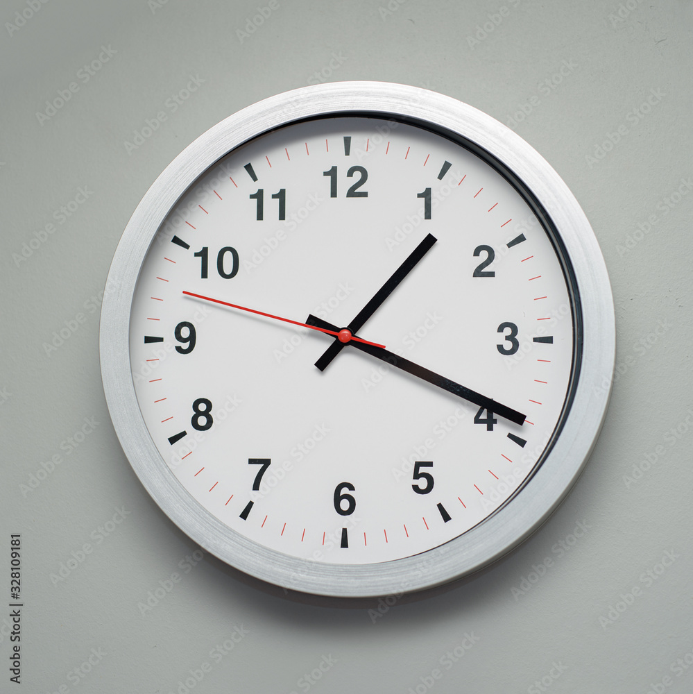 white clock on the gray wall white clock on the gray wall