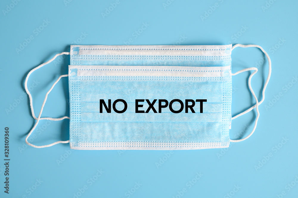 no export text on a blue medical protective masks on blue background, ban on export of masks that protect coronavirus covid-19 from China. top view, flat lay, isolated, nobody. ofl font no export text on a blue medical protective masks on blue background, ban on export of masks that protect coronavirus covid-19 from China. top view, flat lay, isolated, nobody. ofl font