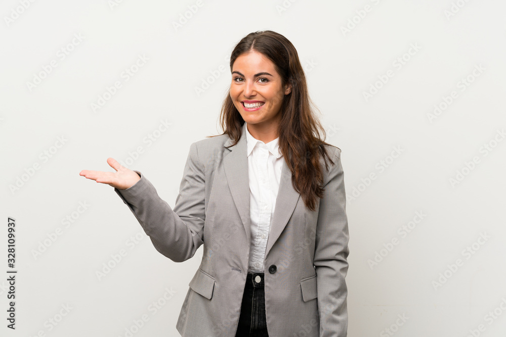 Young business woman over isolated white background holding copyspace imaginary on the palm Young business woman over isolated white background holding copyspace imaginary on the palm