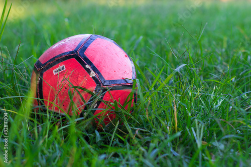 Red Soccer Ball in Grass 