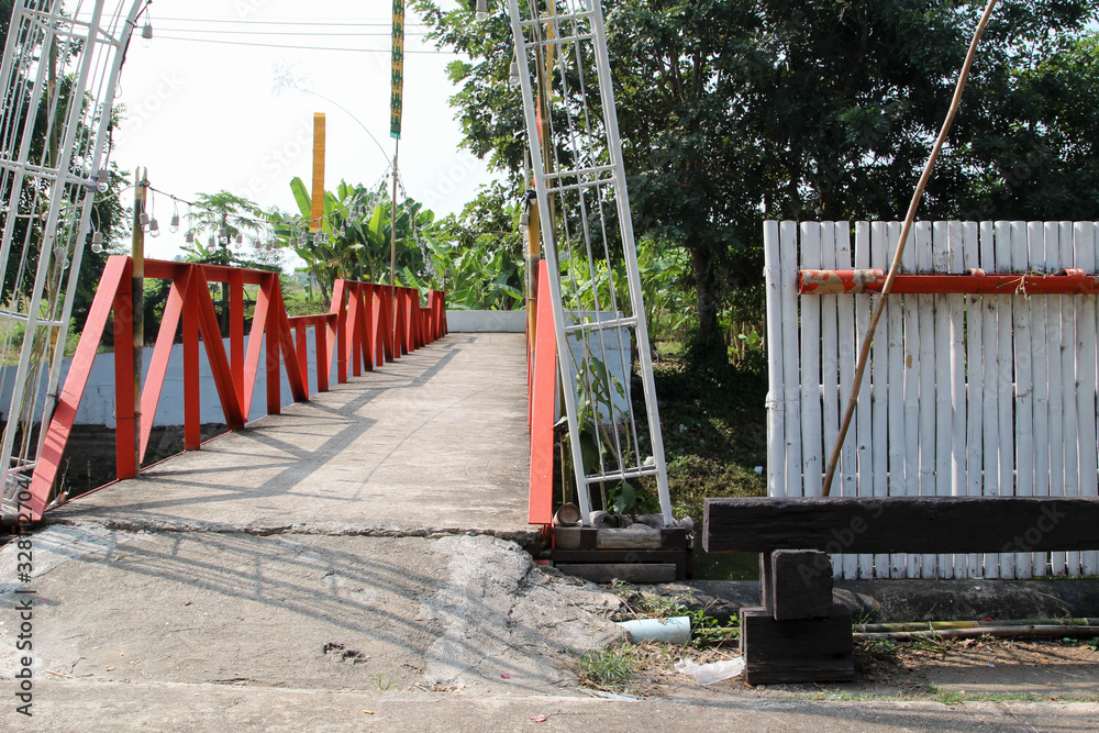 Local small steel bridge over the small river in the village. Local small steel bridge over the small river in the village.