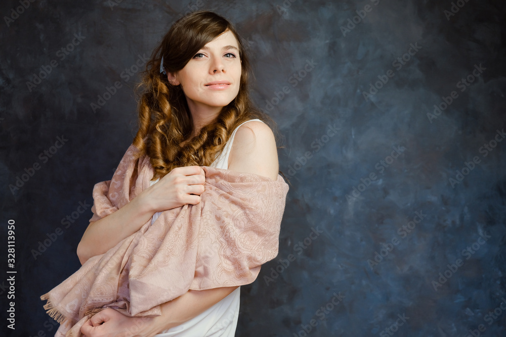 Feminine sensual girl posing on a black background. Portrait of a young European woman with curly brown hair. Femininity and natural beauty. Feminine sensual girl posing on a black background. Portrait of a young European woman with curly brown hair. Femininity and natural beauty.