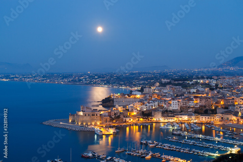 view of the city of Castellammare del Golfo shortly after sunset, with the moonlight