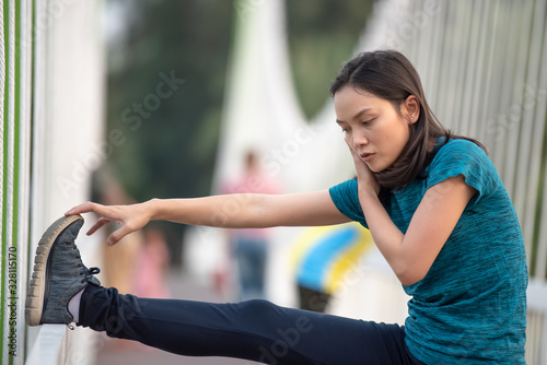 Asian women warm up before exercising in the park.