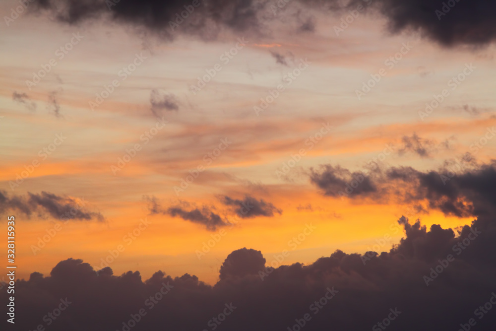 Dramatic red and orange sky and clouds abstract background. Red-orange clouds on sunset sky. Warm weather background. Art picture of sky at dusk
