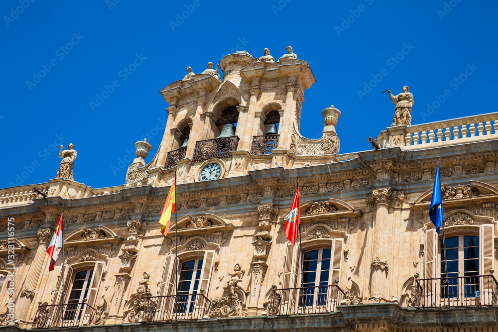 View of the beautiful antique buildings around Plaza Mayor an 18th century Spanish baroque public square surrounded by shops, restaurants and the town hall in Salamanca old city