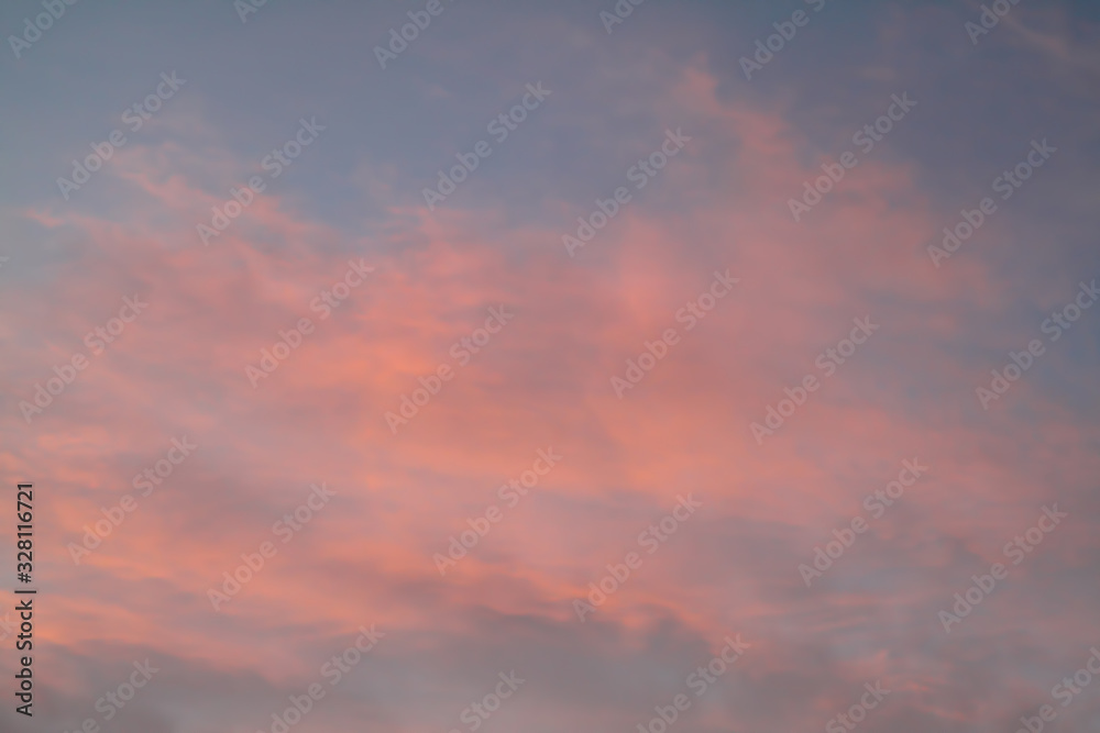 Dramatic red and orange sky and clouds abstract background. Red-orange clouds on sunset sky. Warm weather background. Art picture of sky at dusk