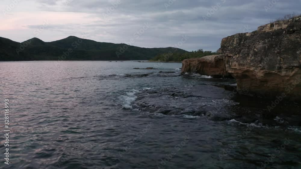 Fiji Islands - Ocean Waves Splashing On The Rocks At The Shore During Sunset - Wide Shot Fiji Islands - Ocean Waves Splashing On The Rocks At The Shore During Sunset - Wide Shot