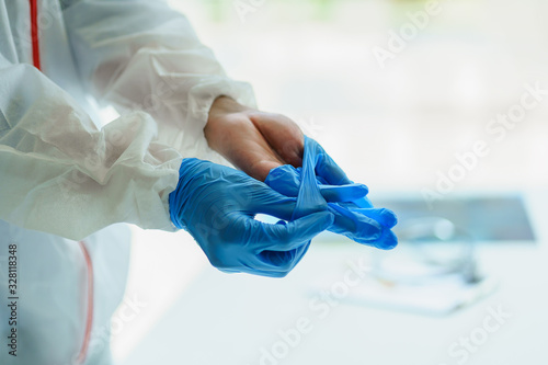 Male doctor wears medical gloves for Protective Epidemic Corona Virus, Covid-19 outbreak concept . photo