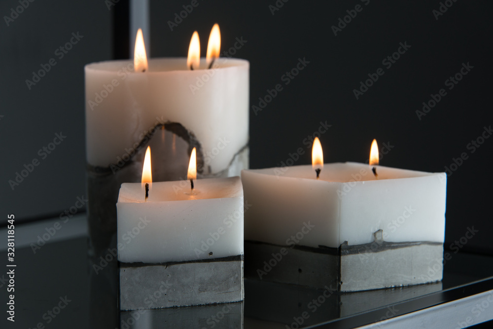 white candle on a concrete base white candle on a concrete base