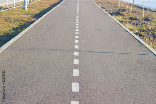 road marking. dividing line on the asphalt. lane for cars and bicycle sepidists.