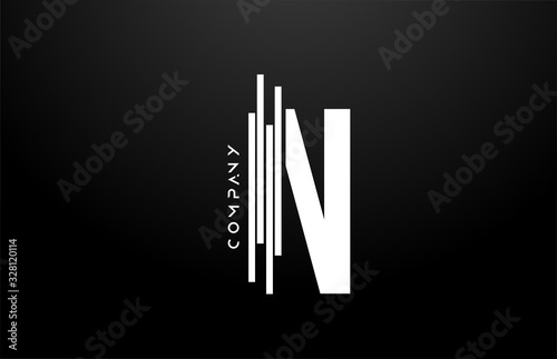 N black white letter alphabet logo design with lines icon for business and company photo