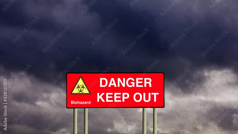 Zoom in to a red road sign warning of danger biohazard and keep out under gathering dark storm clouds. Zoom in to a red road sign warning of danger biohazard and keep out under gathering dark storm clouds.