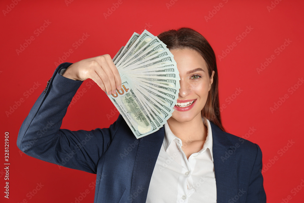 Young woman with money on crimson background Young woman with money on crimson background