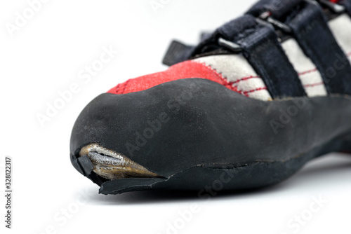 Worn climbing shoe requiring a full upper rubber replacement, isolated on white background.