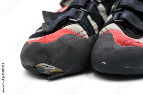 Worn climbing shoes requiring a full upper rubber replacement, isolated on white background.