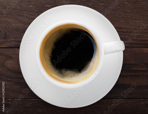 cup of coffee grains on a wooden background