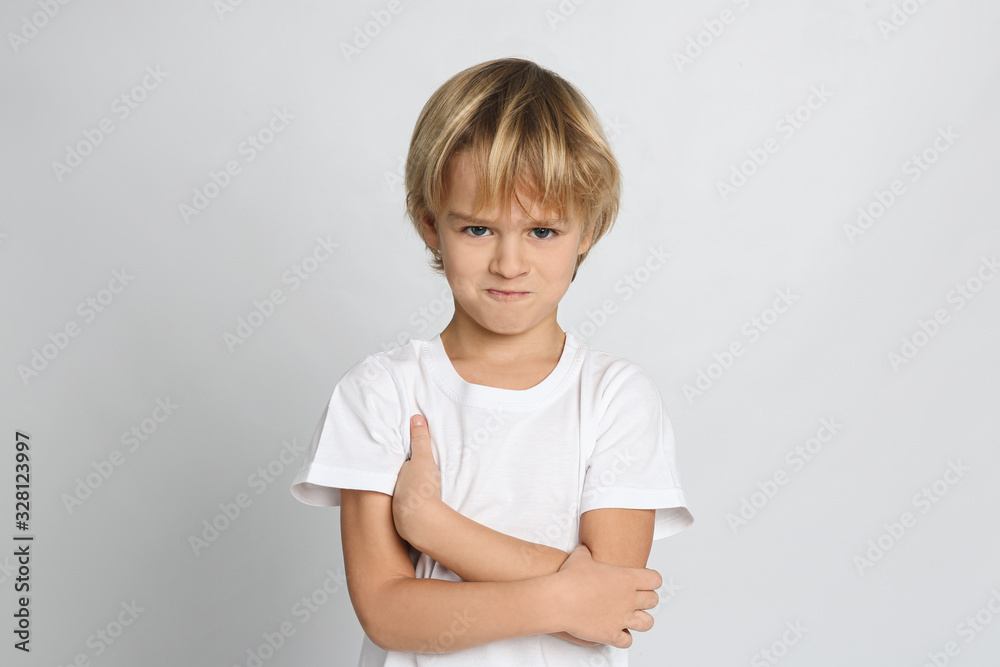 Portrait of cute little boy on light grey background Portrait of cute little boy on light grey background