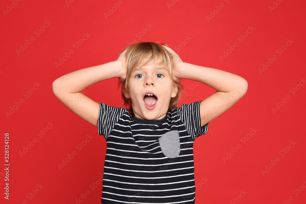 Portrait of emotional little boy on red background Portrait of emotional little boy on red background