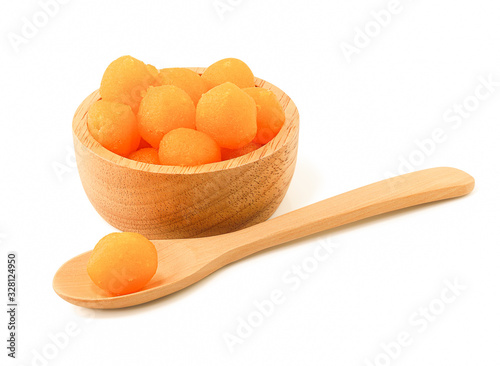 Close up of Gold Egg Yolks Drops or Thong Yod thai dessert in wooden bowl isolated on white background with clipping path, Egg yoke fudge balls cooked in syrup.