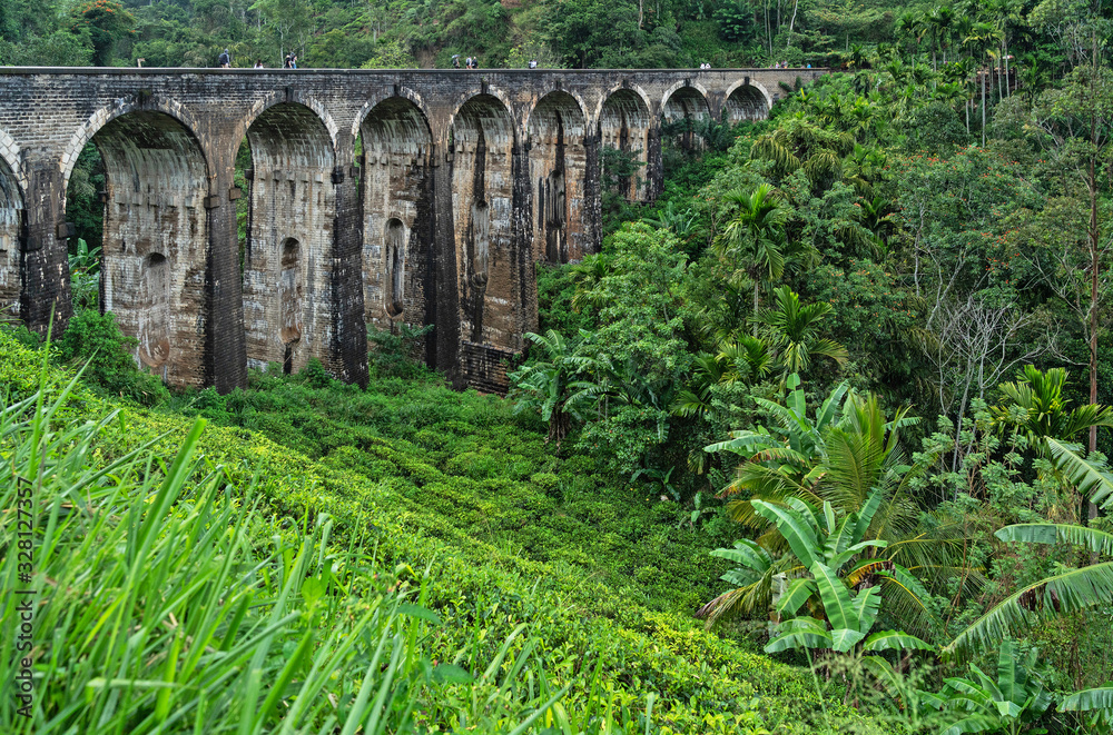 Sri Lanka, Nine Arch Bridge in Ella, tourist architectural landmark, green jungle landscape.