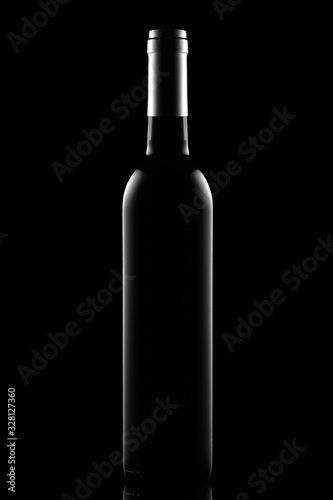 Bottle of dry red wine on a black background