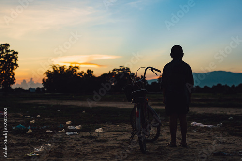 Canvas Print Silhouette picture of poor kids on the land that full of plastic trash and garbage