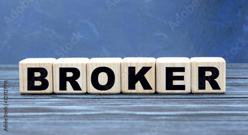 concept word broker on cubes on a blue background