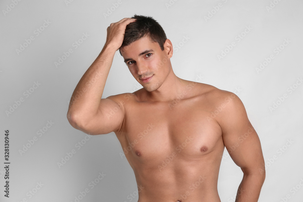 Man with sexy body on light background