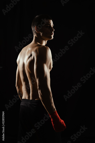 Portrait of male boxer looking over shoulder