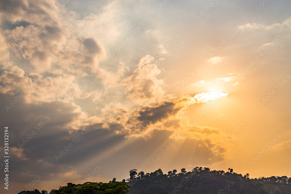 Sunset with clouds and crepuscular rays in evening over the mountain Sunset with clouds and crepuscular rays in evening over the mountain