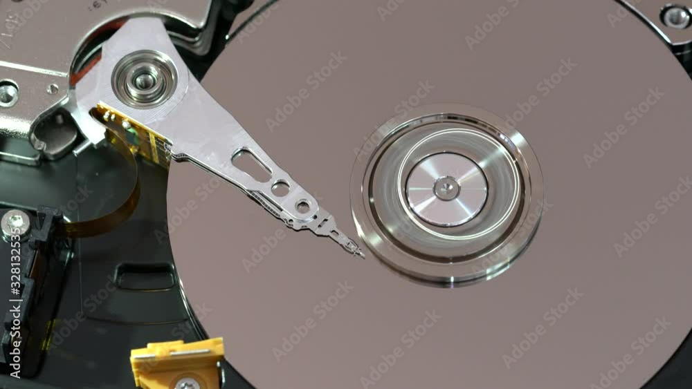 top view on an Internals of SATA hard disk drive working, Operating head of computer hard disk drive or HDD top view on an Internals of SATA hard disk drive working, Operating head of computer hard disk drive or HDD