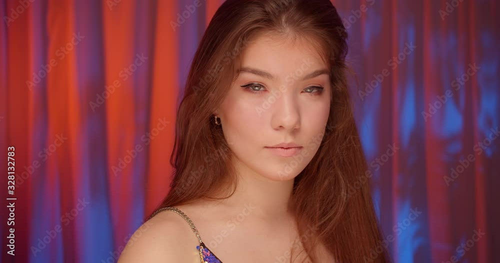 Portrait of caucasian beautiful confident girl neon light look at camera bare shoulders Portrait of caucasian beautiful confident girl neon light look at camera bare shoulders