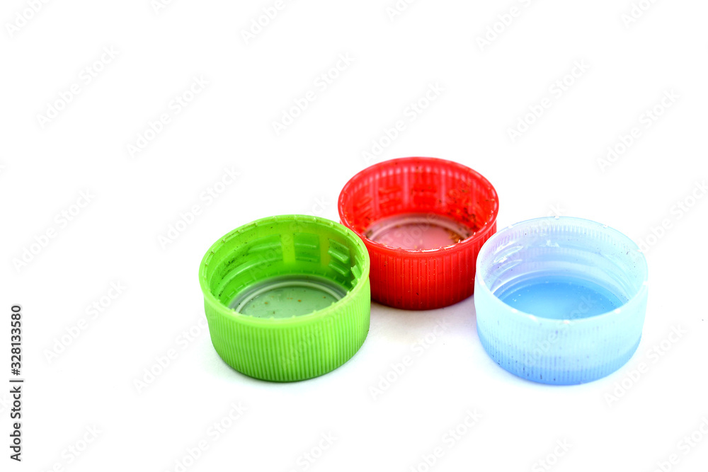 various dirty pet bottle caps on white background various dirty pet bottle caps on white background