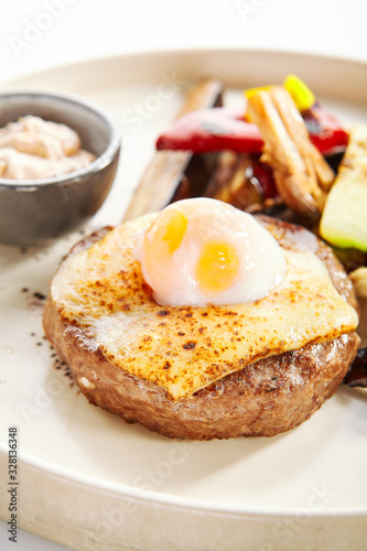 Steak with sous vide egg and baked vegetables