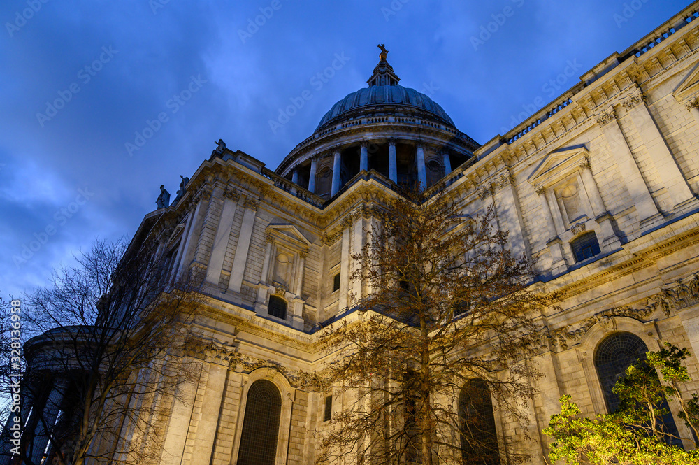 St. Paul's Cathedral in London, UK. Evening view of St Paul's taken from the southeast of the cathedral. Illuminated building, blue sky and clouds