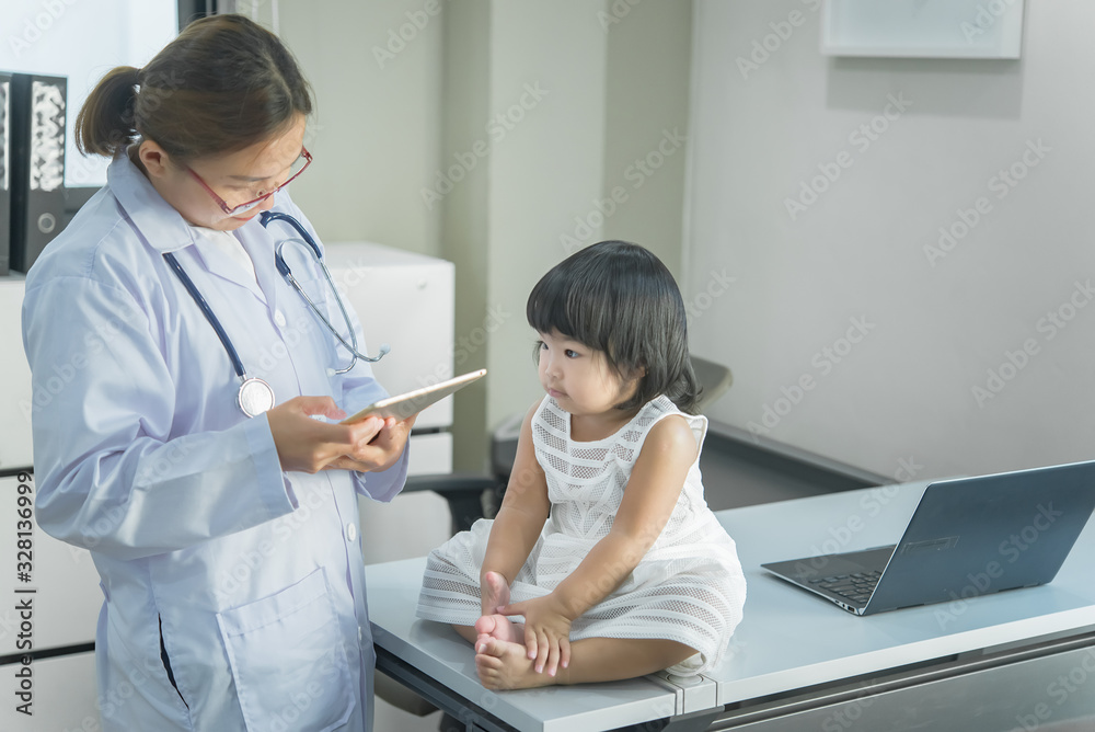 Asian doctor has a stethoscope to check his breathing and heart of a lovely girl, check the health of children,Thailand people Asian doctor has a stethoscope to check his breathing and heart of a lovely girl, check the health of children,Thailand people