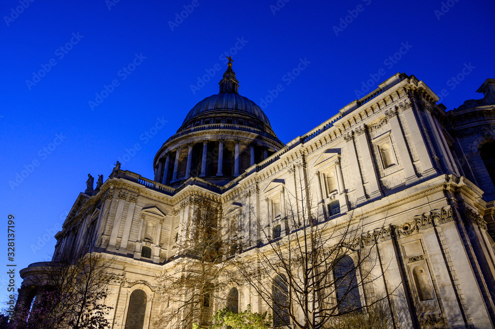 St. Paul's Cathedral in London, UK. Evening view of St Paul's taken from the southeast of the cathedral. Illuminated building and clear dark blue sky