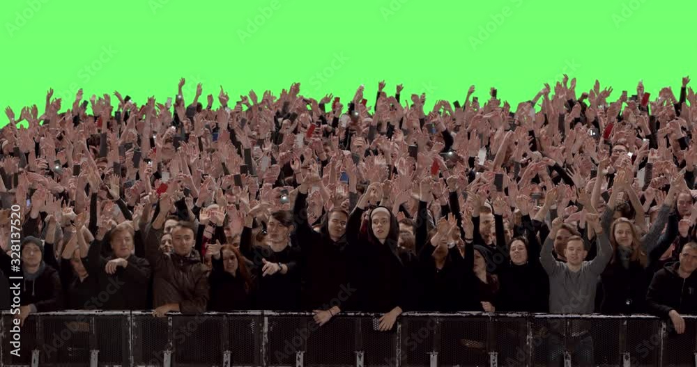 GREEN SCREEN CHROMA KEY Model released, Front view of huge crowd dancing and cheering at a concert or a show behind control barrier. Shot on RED Helium 8K Prores 4444