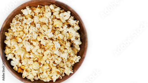 photo sweet popcorn on a white background wooden bowl top view