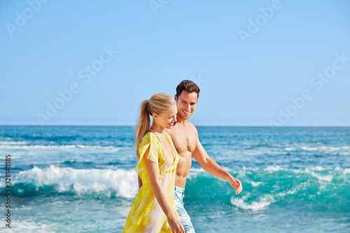 Couple walking on the beach photo