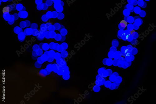 Large blue blurry lights on an isolated black background. Texture for banner, postcards. Fabulousness photo