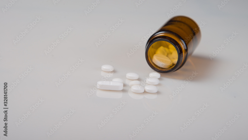 Pharmaceutical concept. Pills with a bottle on a light background. Pharmaceutical concept. Pills with a bottle on a light background.