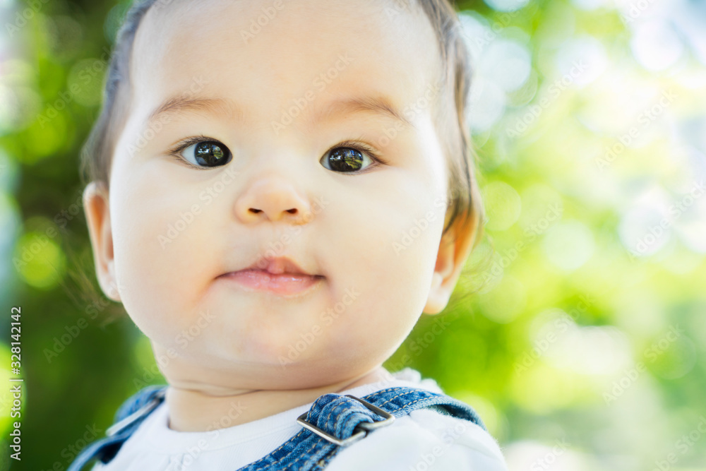 Asian-Caucasian baby girl portrait with sparkly eyes outdoors Asian-Caucasian baby girl portrait with sparkly eyes outdoors