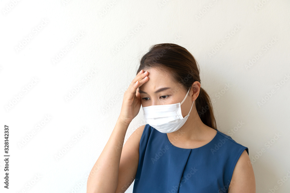 Sick young woman in medical face mask suffer in headache because of air pollution in the city building, concept of pollution,dust allergies. close up and copy space Sick young woman in medical face mask suffer in headache because of air pollution in the city building, concept of pollution,dust allergies. close up and copy space
