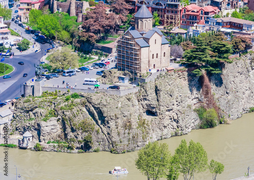 View of Tbilisi city from Narikala Fortress, old town and modern architecture. The Metekhi temple. Georgia photo